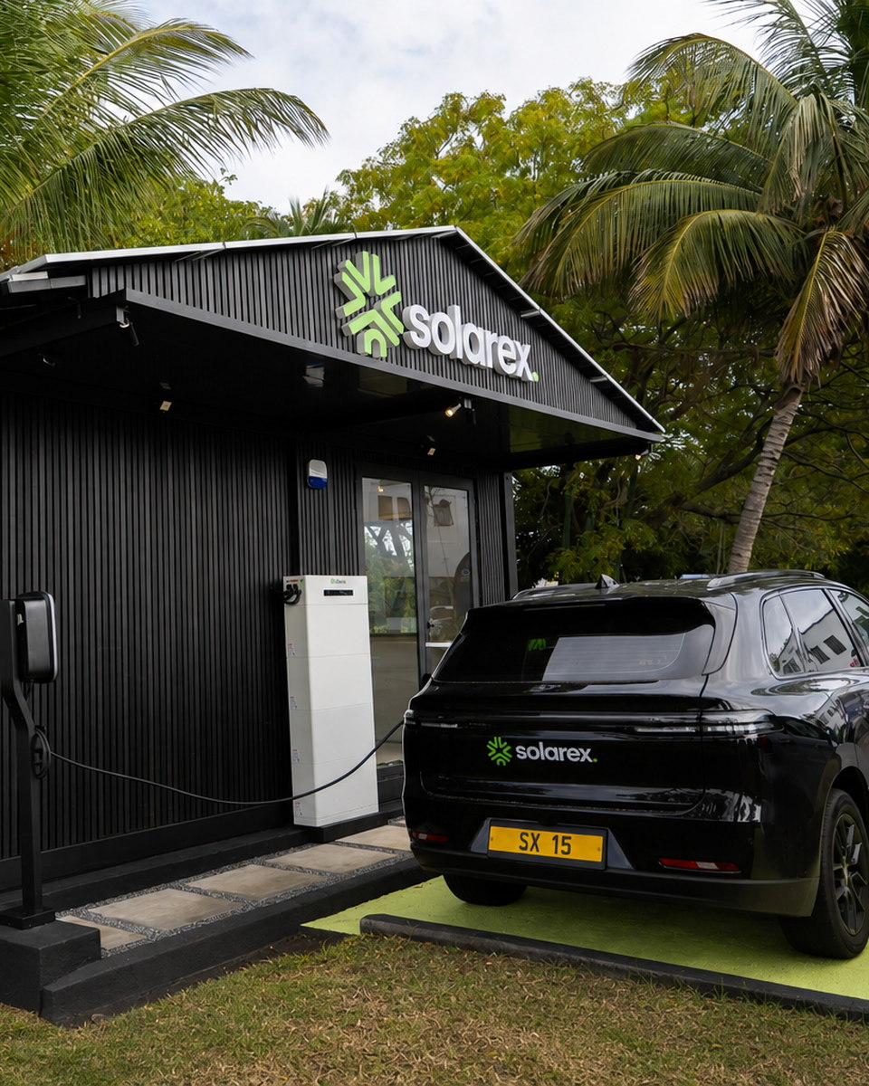 The Cube — Solarex Experience Center in Cap Tamarin, with its battery stack, EV charger and a Solarex electric vehicle on the charging bay
