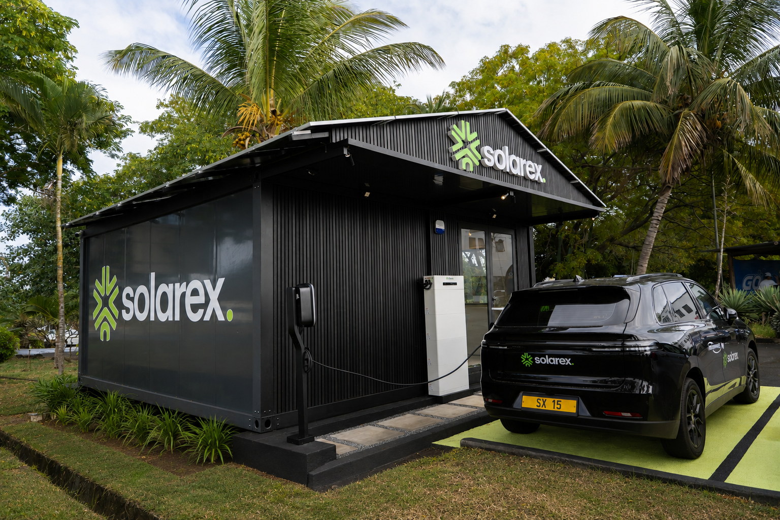 The Solarex Experience Center at Cap Tamarin — the Cube building with its battery stack, EV charger and a Solarex electric vehicle on the charging bay