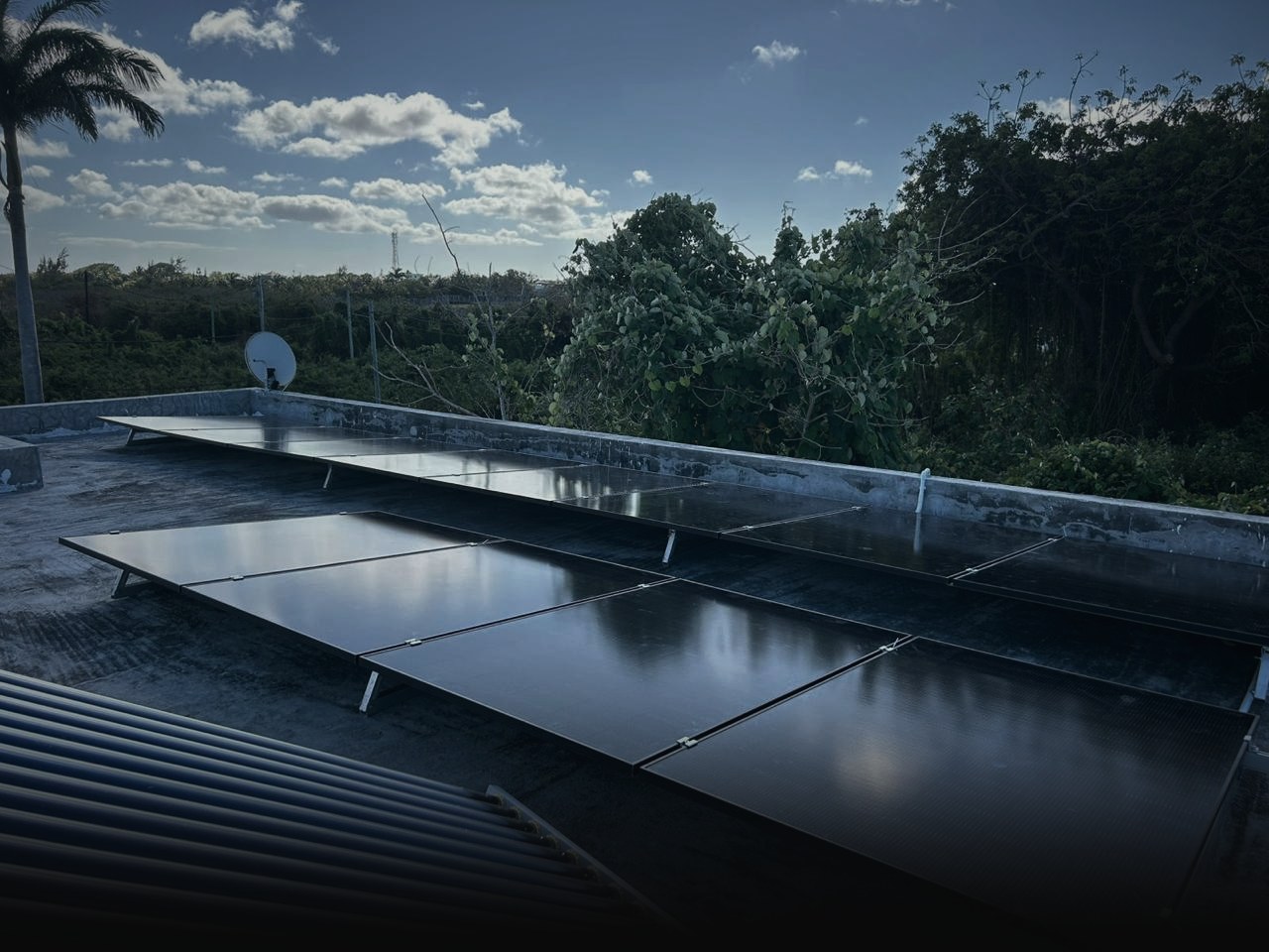 Solar panels flush-mounted on a flat concrete roof in Mauritius