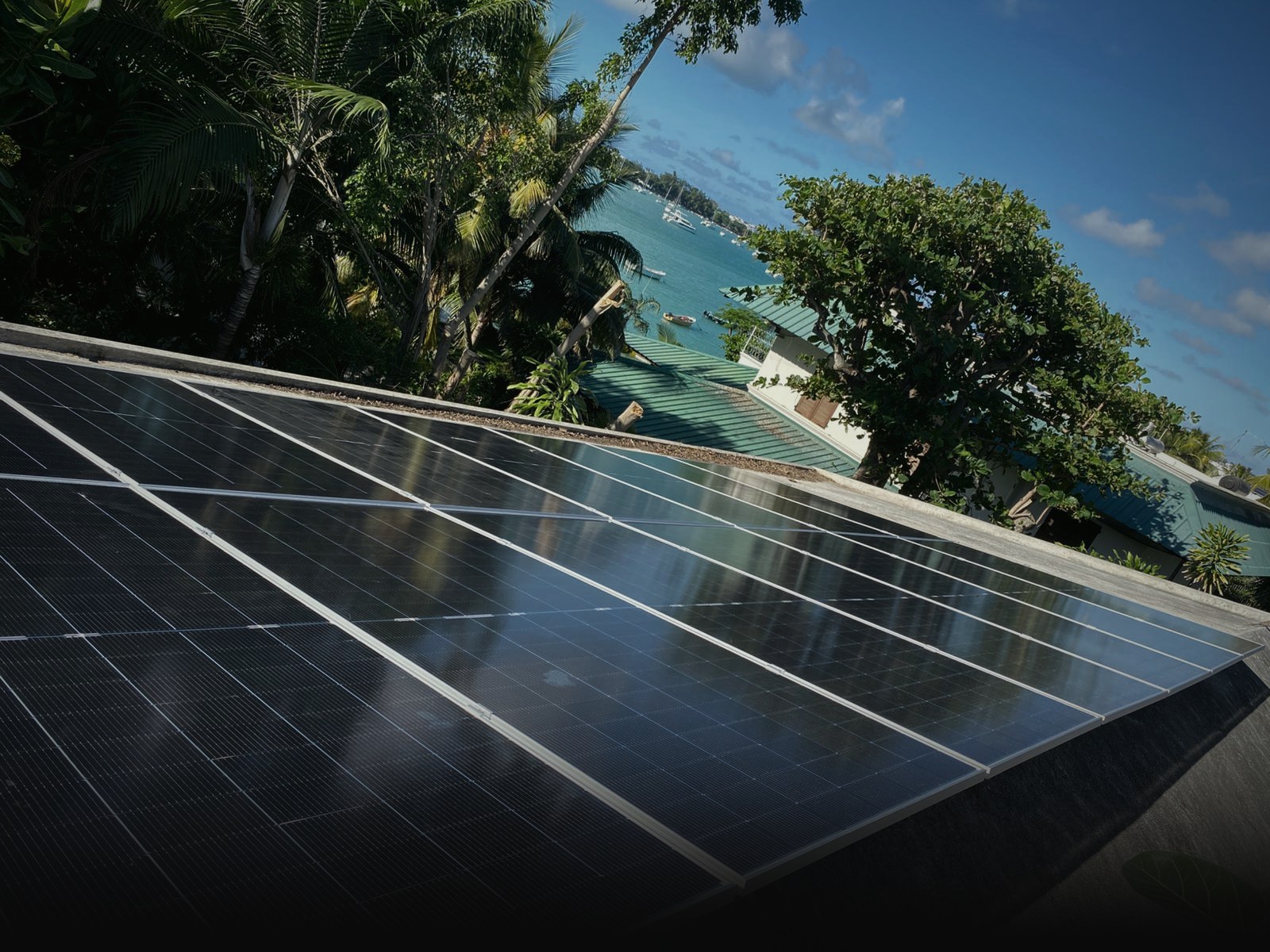 Tilt-mounted solar panels on a flat concrete roof in Mauritius