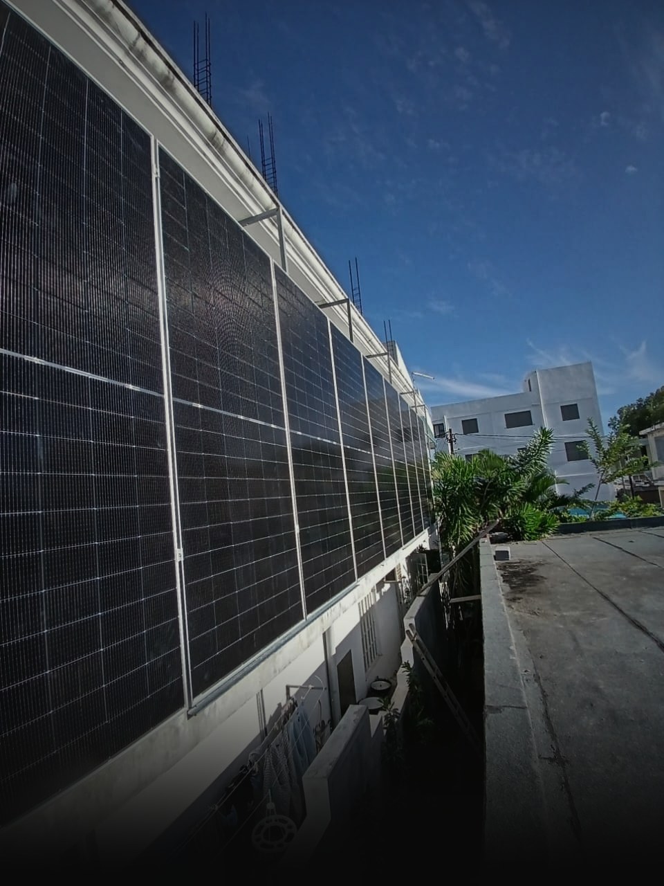 Vertical façade-mounted bifacial solar panels on a building wall in Mauritius
